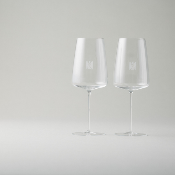 Two wine glasses with flat bottoms and the VDP.Adler logo...